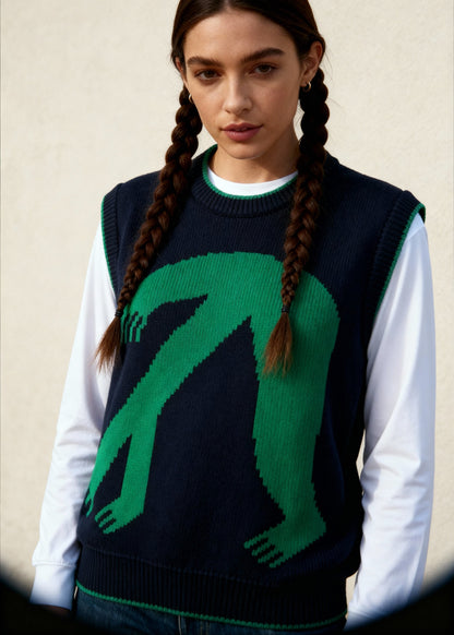 Person wearing a dark sweater with a green graphic design against a neutral background
