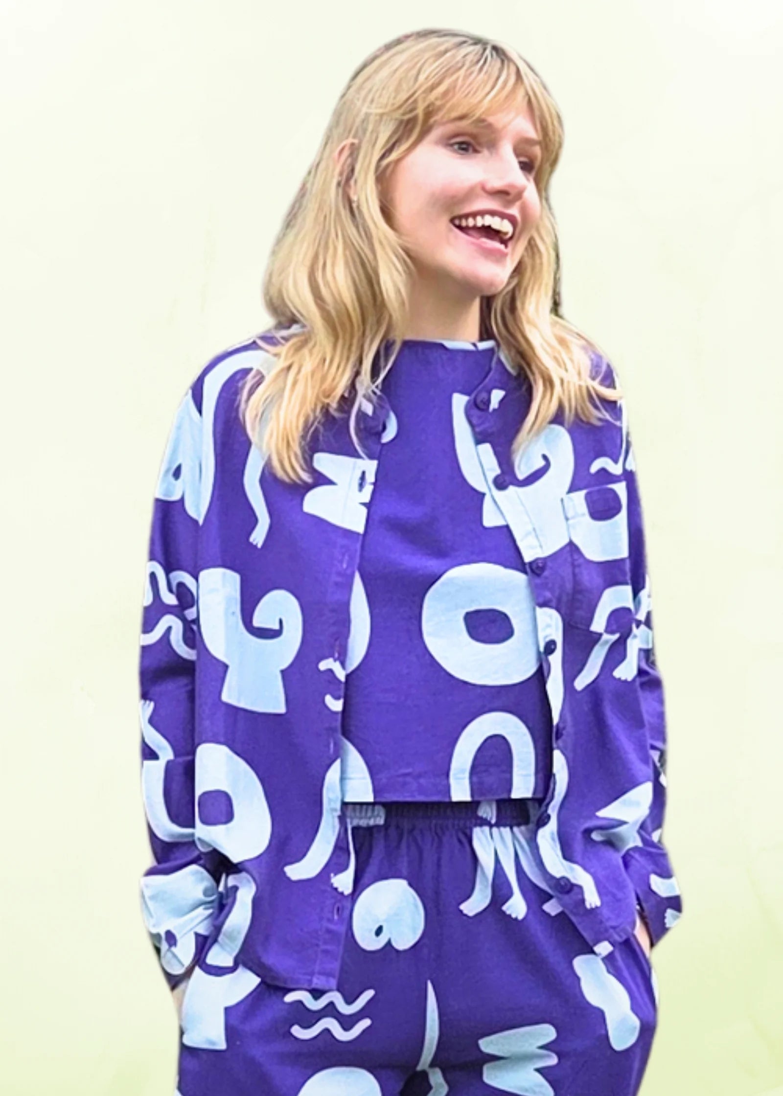 Person wearing a blue outfit with light blue patterns on a light yellow background