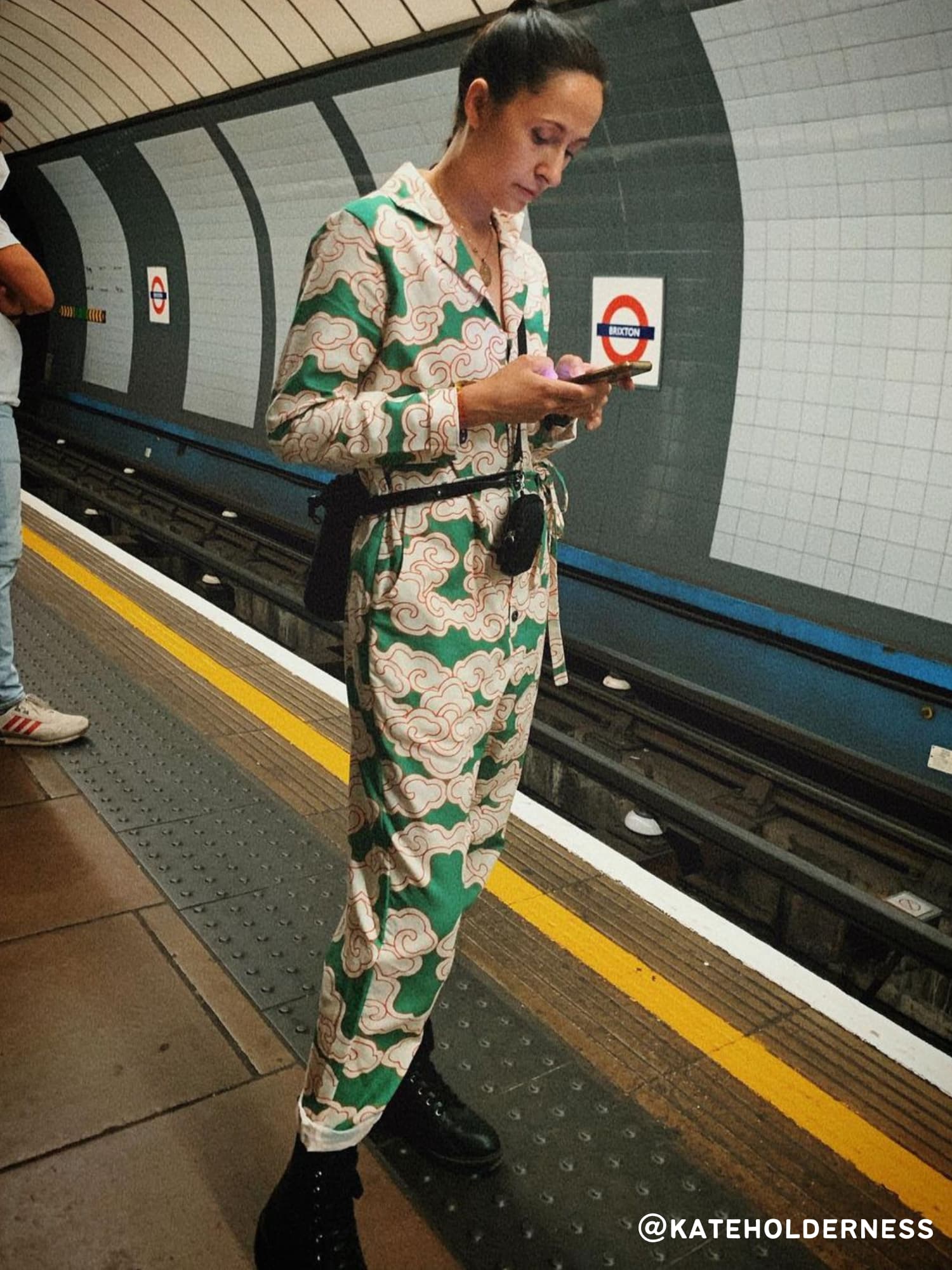 Kate Holderness wears the Green Clouds Jumpsuit by Wild Clouds whilst waiting for the tube.
